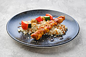 Chicken and vegetable skewers on rice