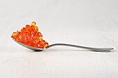 Spoon with salmon red caviar.