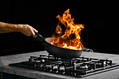 Flambé a dish in a pan