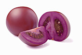 Whole and sliced purple tomatoes