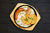 Potato pancakes with sausage and pork belly in cream sauce