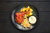 Grilled chicken leg with roast potatoes and coleslaw