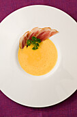 Sweet potato soup with bacon and parsley