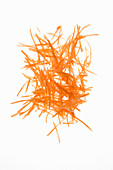 Grated carrots on a white background
