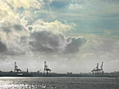 Silhouette of Red Hook container terminal and waterfront with dramatic sky, Brooklyn, New York City, New York, USA