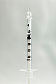 Botox syringe on light gray background