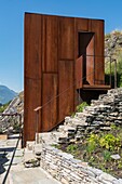 Switzerland, Valais, Sion, walk on the Bisse de Clavau, in the middle of the vines the rusty cube of Varonne (contemporary vineyard hut) offers the passer by a local gastronomy