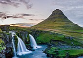 Iceland, Western Region, Grundafjordur, Kirkjufell and Kirkjufellsfoss falls at sunset