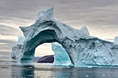 Greenland, North West coast, Inglefield Fjord towards Qaanaaq, iceberg forming an arch