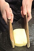 France, Ille et Vilaine, Emerald Coast, Saint Malo, La Maison du Beurre Bordier, fuss of butter to form platelets