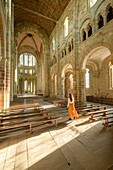 France, Manche, the Mont-Saint-Michel, young woman in church interior's