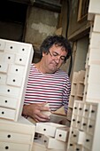 France, Jura, Lajoux, the layetier Bruno Marelle in his workshop of layeterie makes furniture with drawers