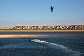 Morocco, Western Sahara, Dakhla, kitesurfer on the lagoon, between the White Dune and the desert mountains
