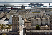 France, Seine Maritime, Le Havre, Downtown rebuilt by Auguste Perret listed as World Heritage by UNESCO, Perret buildings around the cultural center called Volcano created by Oscar Niemeyer, a container ship in the background leaves the commercial port