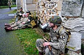 France, Eure, Chambray, Allied Reconstitution Group (US World War 2 and french Maquis historical reconstruction Association), reenactors in uniform of the 101st US Airborne Division resting in front of the church
