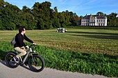 France, Seine-Maritime, Norman Seine River Meanders Regional Nature Park, Sahurs, chateau de Trémauville and cyclist on the veloroute of the Val de Seine
