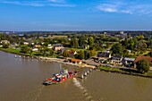 France, Seine-Maritime, Pays de Caux, Norman Seine River Meanders Regional Nature Park, the ferry crossing the Seine at Jumieges which abbey is in the background