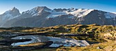 France, Hautes Alpes, the Grave, on the plateau of Emparis panoramic view of the Black Lake facing the massif of Meije at sunrise