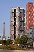 France, Paris, Buildings of Front de Seine and Beaugrenelle shopping center by Valode et Pistre architect firm and the Eiffel Tower