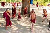 Myanmar (Burma), Mandalay region, Buddhist archeological site of Bagan, young novices in a monasyere playing football