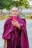 Myanmar (Burma), Mandalay region, Buddhist archeological site of Bagan listed as World Heritage by UNESCO, Ananda pahto temple, selfie of a monk
