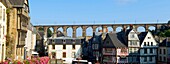 France, Finistere, Morlaix, place Allende, house of the Queen Anne, 16 th century half timbered house and the viaduct in the background