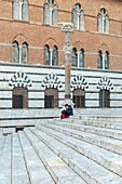 Italy, Tuscany, Siena, historical center listed as World Heritage by UNESCO, facade of Palazzo del Vescovo (Episcopal palace) next to the western facade of Notre Dame de l'Assomption cathedral