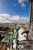 France, Paris, area listed as World Heritage by UNESCO, Ile de la Cite, the Notre Dame Cathedral, the spire dominates the statues of green copper of twelve apostles with the symbols of four evangelists. Viollet-le-Duc has represented himself under saint Thomas's features with his set square