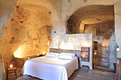 Italy, Basilicata, Matera, troglodyte old town listed as World Heritage by UNESCO, European Capital of Culture 2019, Sasso Barisano, Hotel Sextantio (The Cave of the Civita), room dug into the tuff