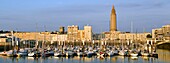 France, Seine Maritime, Le Havre, city rebuilt by Auguste Perret listed as World Heritage by UNESCO, Anse de Joinville, marina with the bell tower of the Church of Saint Joseph at the bottom