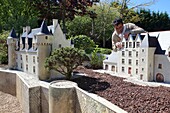 France, Indre et Loire, Loire valley listed as World Heritage by UNESCO, Amboise, Mini-Chateau Park, Guy Perier art maquetist in front a model