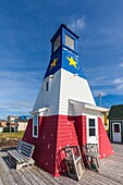 Canada, Nova Scotia, Cabot Trail, Cheticamp, town lighthouse painted in Acadian colors