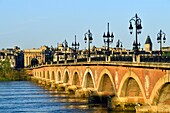 France, Gironde, Bordeaux, area listed as World Heritage by UNESCO, Pont de Pierre on the Garonne River, brick and stone arch bridge inaugurated in 1822 and Bourgogne gate