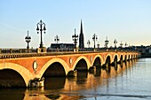 France, Gironde, Bordeaux, area listed as World Heritage by UNESCO, Pont de Pierre on the Garonne River and Saint Michel Basilica built between the 14th and 16th century Gothic style and it's tower of 114 m high