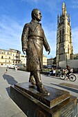 France, Gironde, Bordeaux, area listed as World Heritage by UNESCO, district of the Town Hall, Pey Berland Square, statue representing Jacques Chaban-Delmas by Jean Cardot and the tower Pey Berland, the bell tower of the Saint Andre cathedral