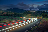 View of trail lights and Long Mountains at dusk near Nouvelle Decouverte, Mauritius, Indian Ocean, Africa