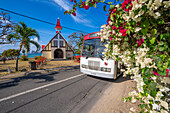 View of local bus and Notre-Dame Auxiliatrice de Cap Malheureux, Cap Malheureux, Mauritius, Indian Ocean, Africa