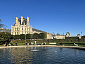 People sitting in the Tuileries Park near the Louvre, Paris, France, Europe