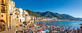 Panoramablick auf Touristen am Strand, Berge im Hintergrund, Cefalu, Provinz Palermo, Sizilien, Italien, Mittelmeer, Europa
