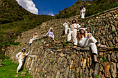Women dressed in llama onesies at the llama wall at Choquequirao, Peru, South America