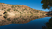 Usa, New Mexico, Abiquiu, Rio Chama, Hills reflected in Chama River