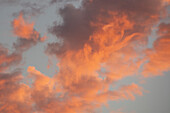 Peach colored clouds on sky at sunset