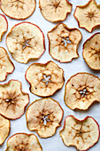 Overhead view of baked apple slices on white background