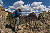 USA, Colorado, Creede, Woman looking at smart phone on trial in San Juan Mountains