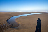 USA, Oregon, Shadow of a person at Cannon Beach 