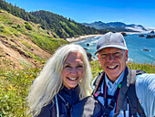 USA, Oregon, Senior couple poses for selfie near Cannon Beach