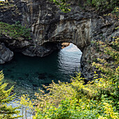 Natural arch formation above rippled sea 