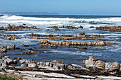 South Africa, Hermanus, Rocky coastline and sea at Onrus Beach