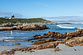 South Africa, Hermanus, Rocky coast and Kammabaai Beach at sunny day