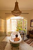 Boy (10-11) taking bath in large bathing suite